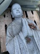 Carved stone statue of a standing Buddha