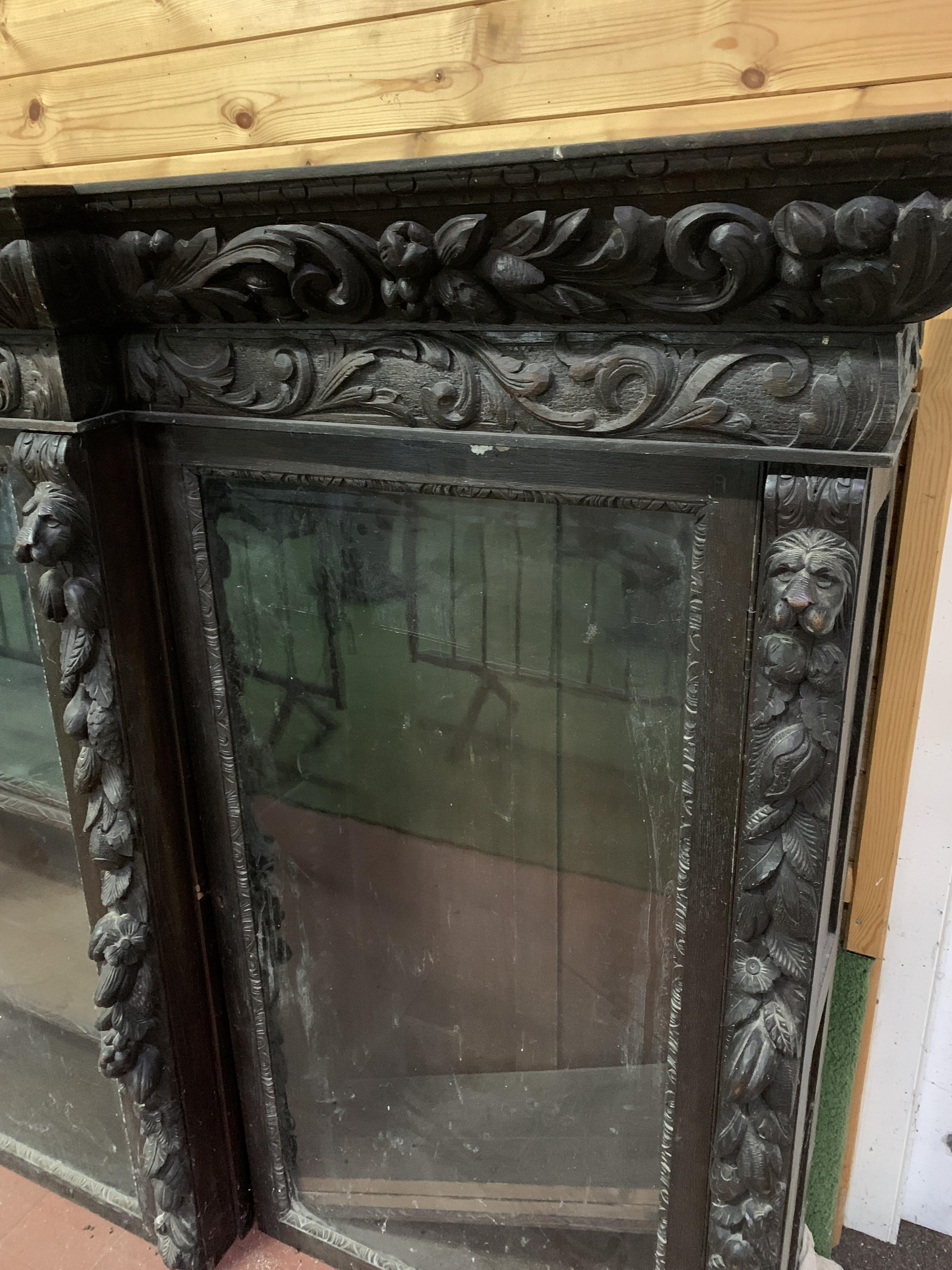 Victorian heavily carved glazed bookcase over four cupboards - Image 3 of 10