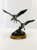 Bronze sculpture of geese on marble and wood base