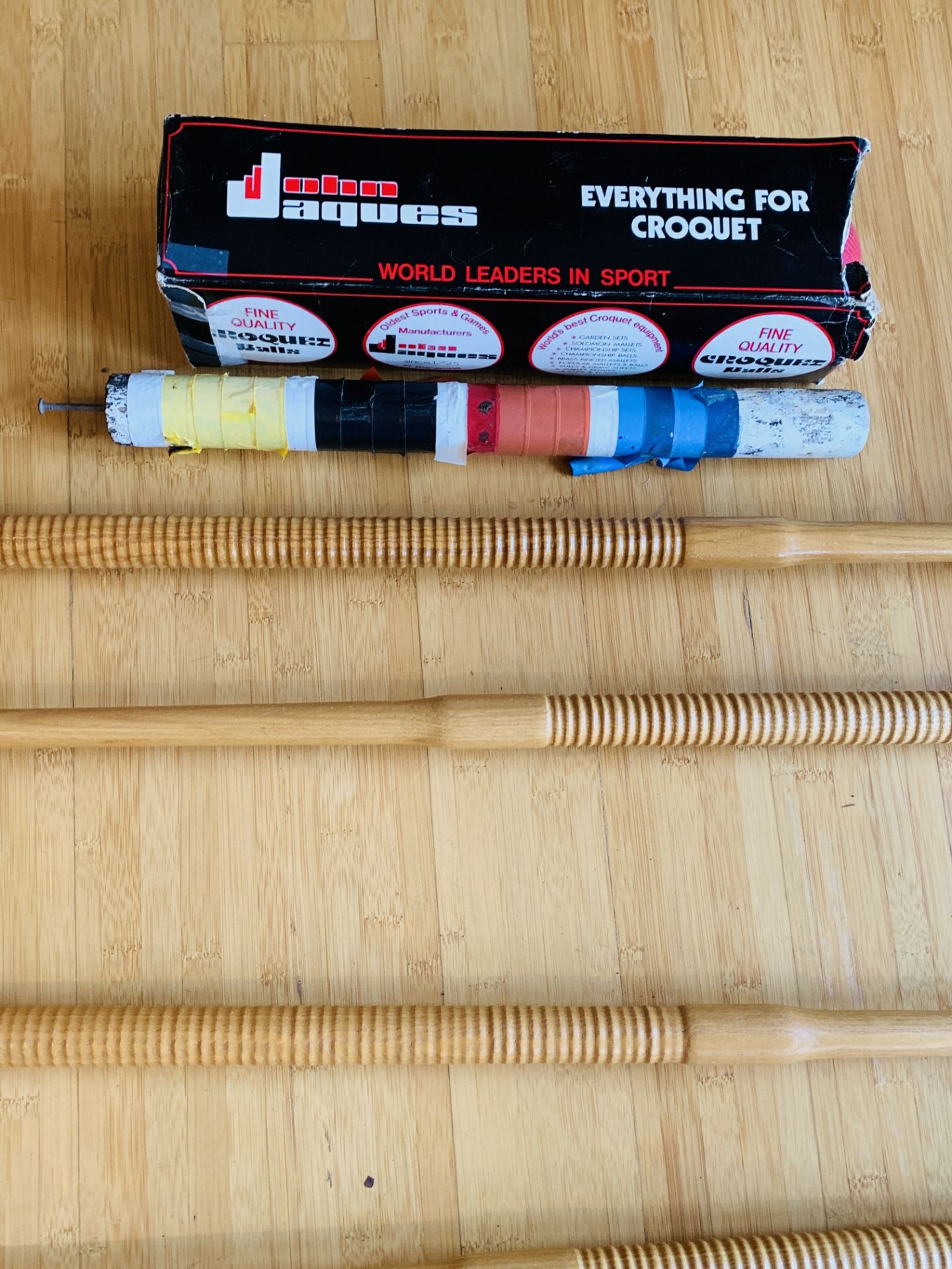 Four wooden Jaques croquet mallets, and 4 balls.