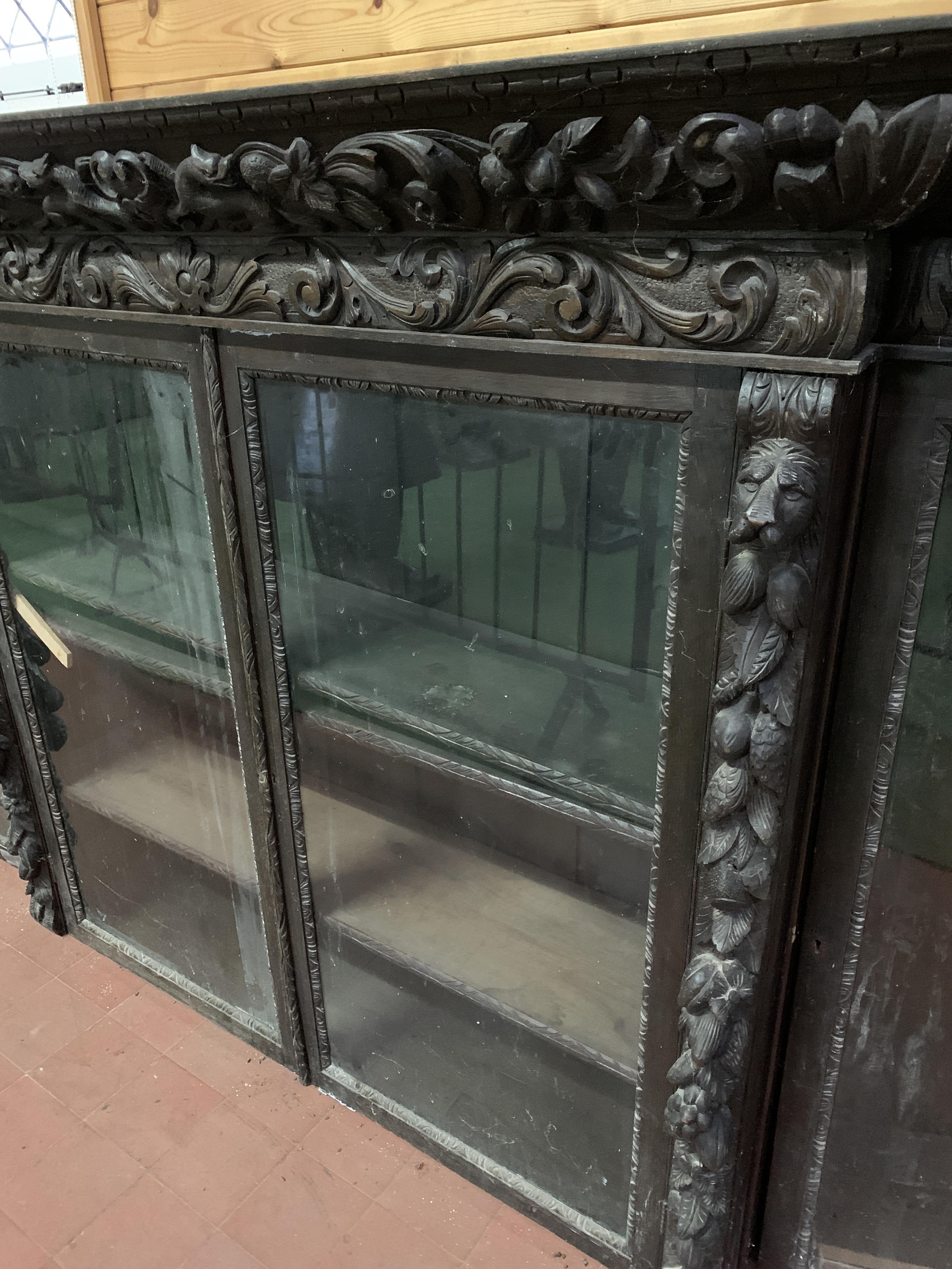 Victorian heavily carved glazed bookcase over four cupboards - Image 2 of 10