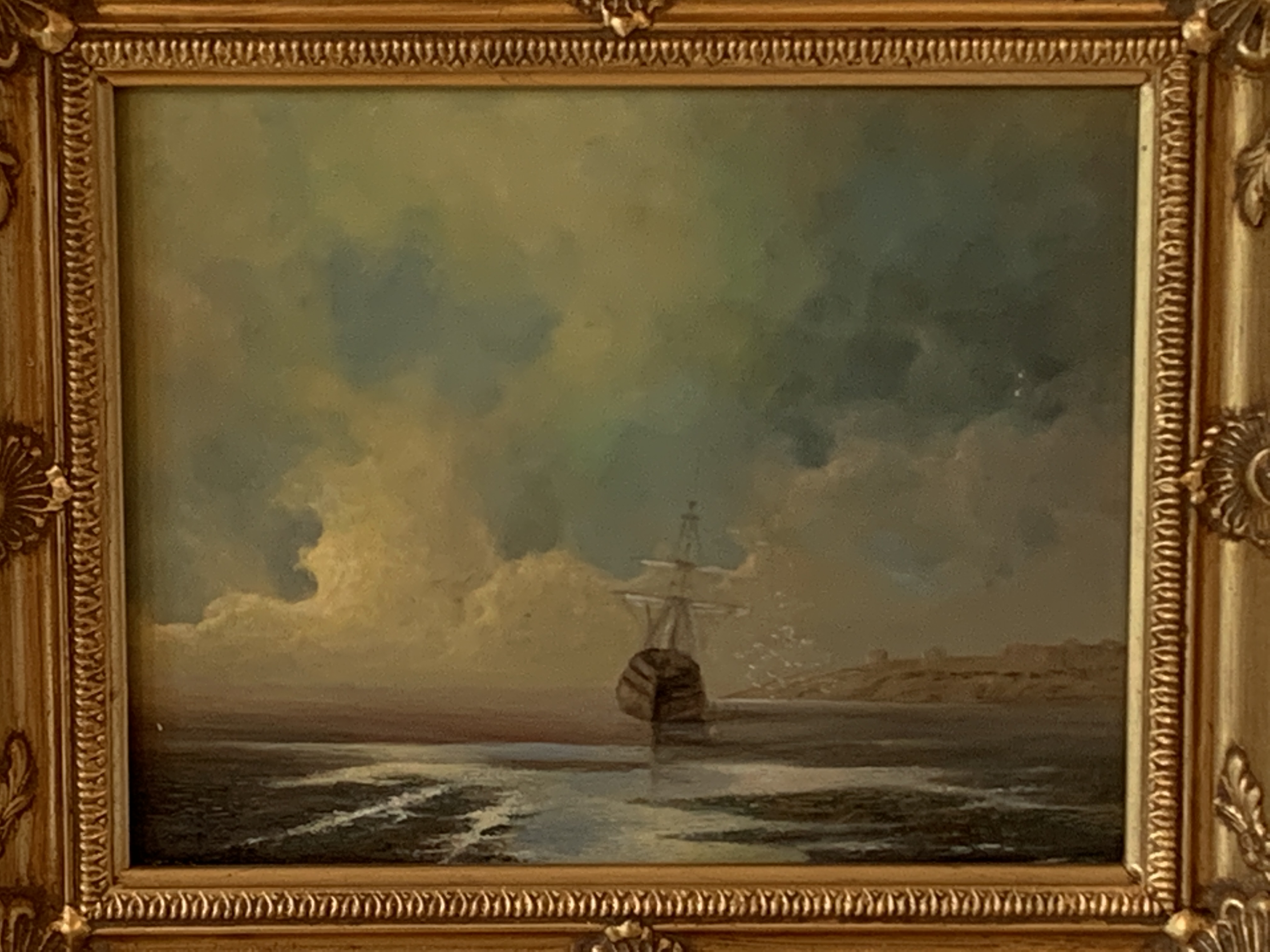 Pair of gilt framed oils on board of ships on a beach