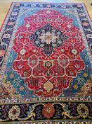 Red and blue ground wool Tabriz carpet