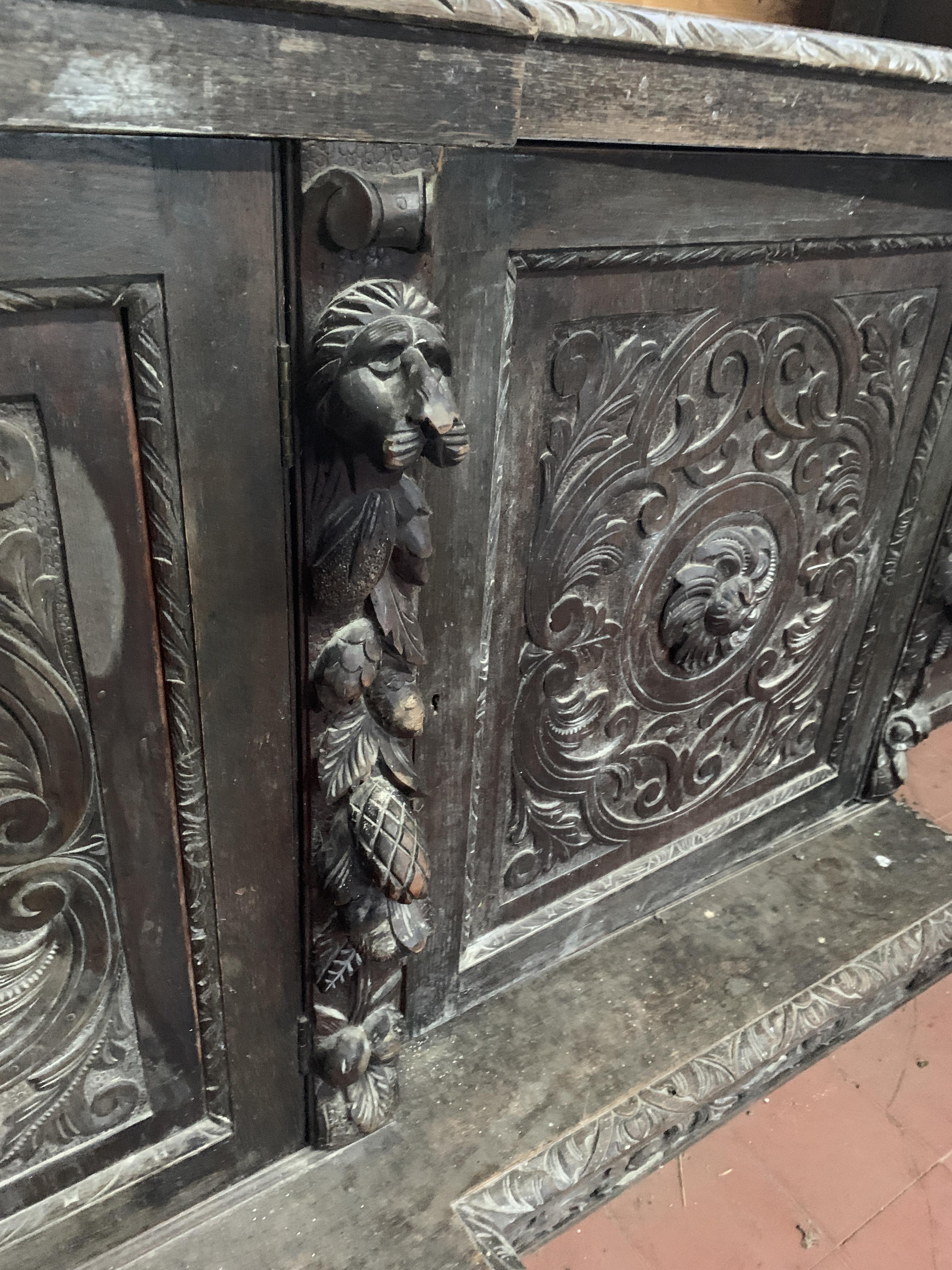 Victorian heavily carved glazed bookcase over four cupboards - Image 10 of 10