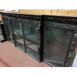 Victorian heavily carved glazed bookcase over four cupboards