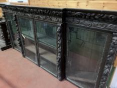 Victorian heavily carved glazed bookcase over four cupboards