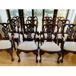 A set of twelve hardwood dining chairs