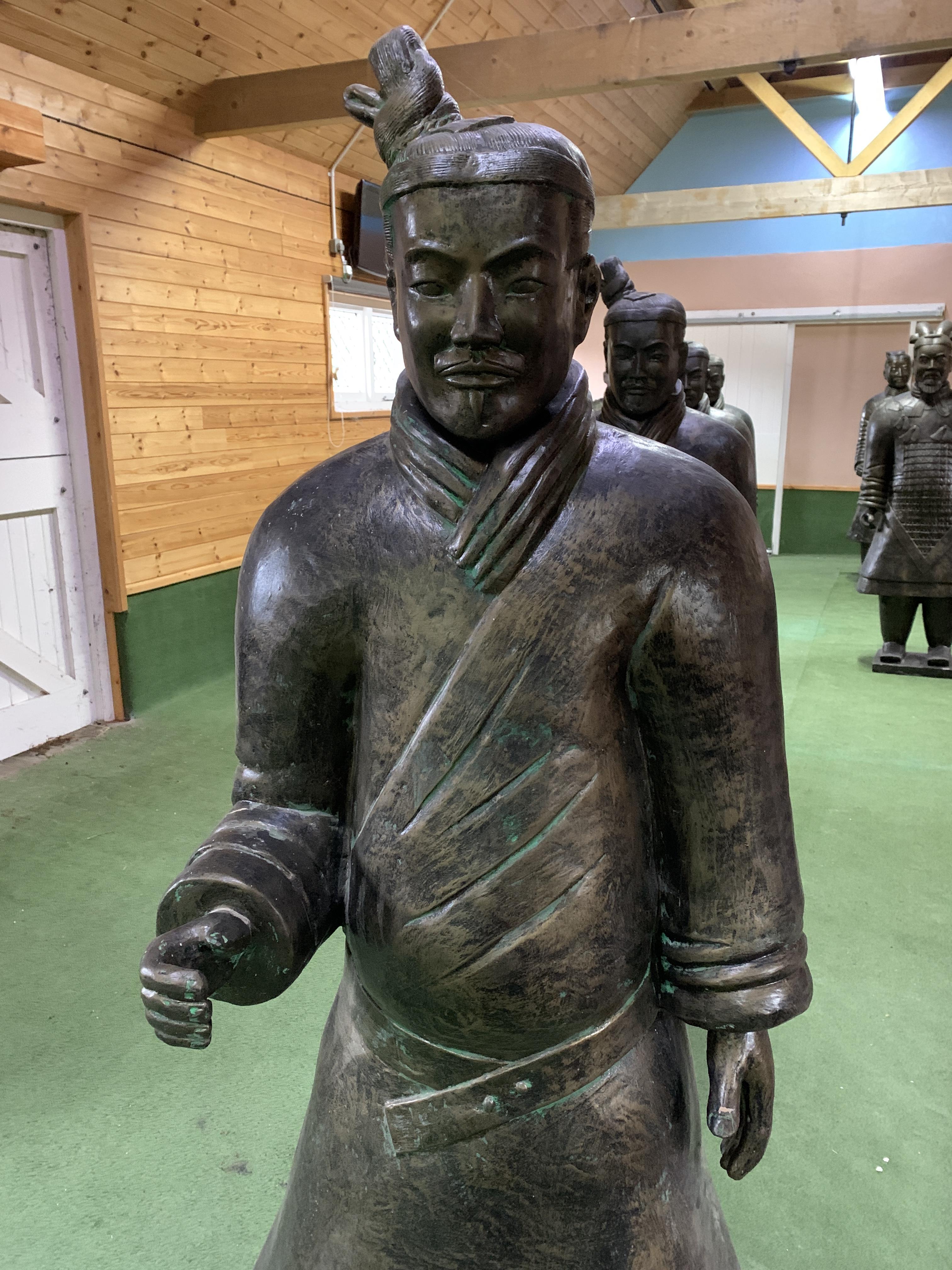 A Qin style terracotta figure of a standing soldier