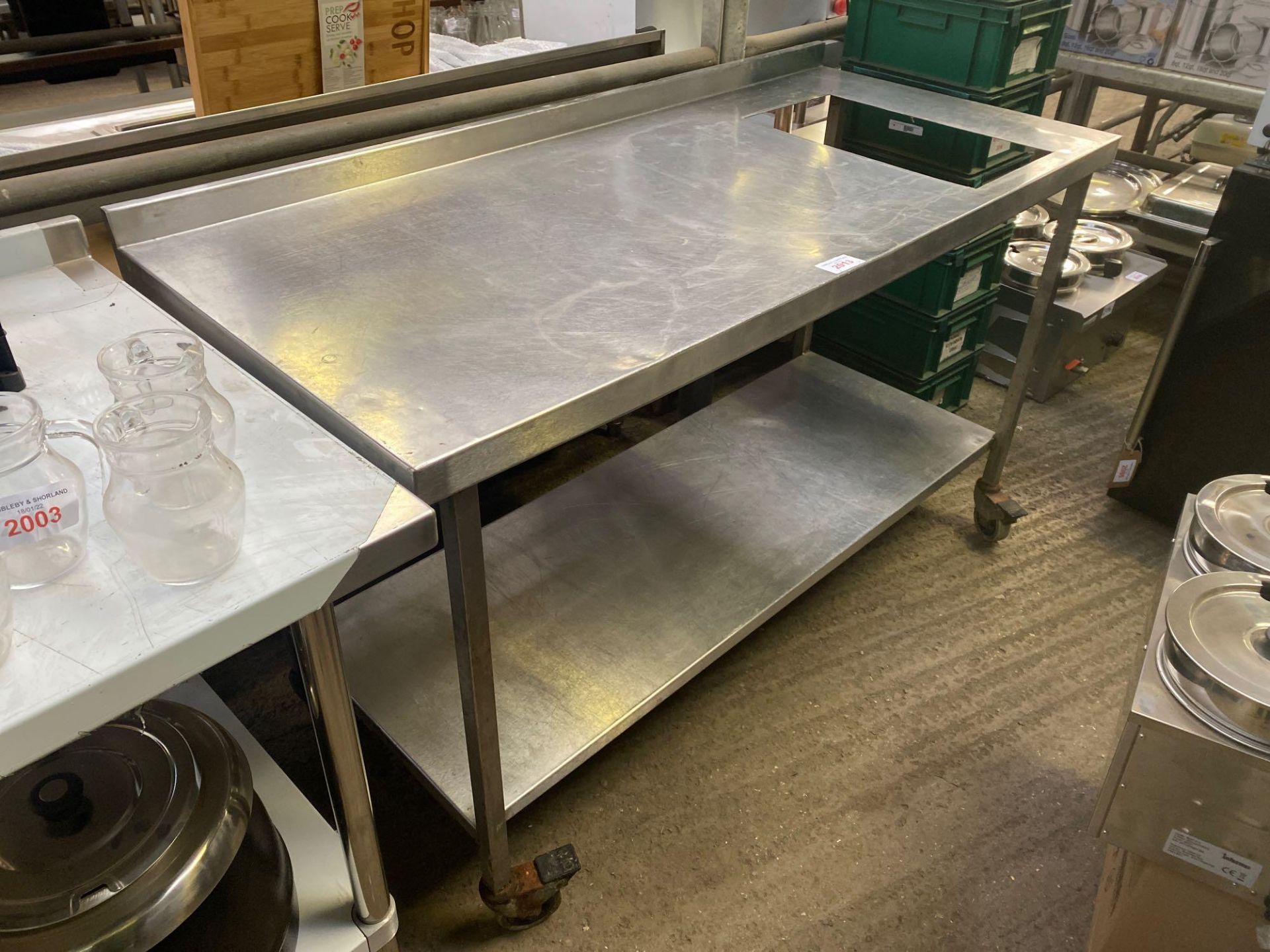 Mobile preparation table with undershelf and cut out.