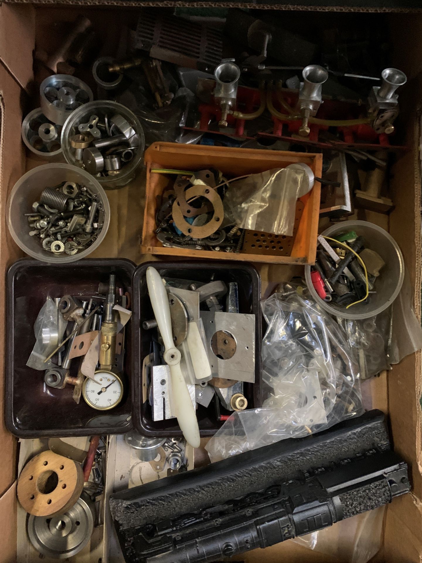 Two trays of assorted model making parts together with a quantity of model making plans