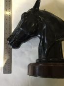 Pair of very heavy horse's heads mounted on turned hardwood bases