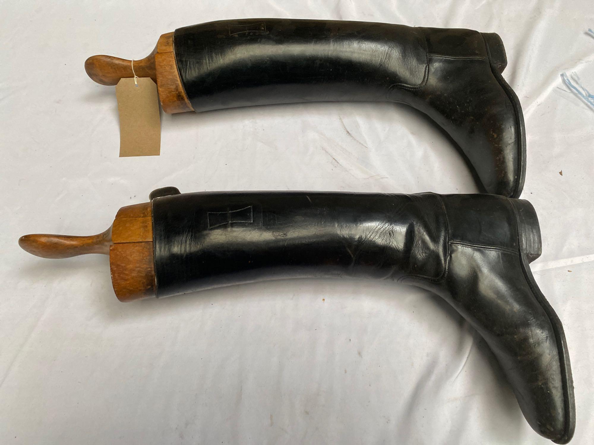 A pair of black leather long riding boots complete with wooden trees