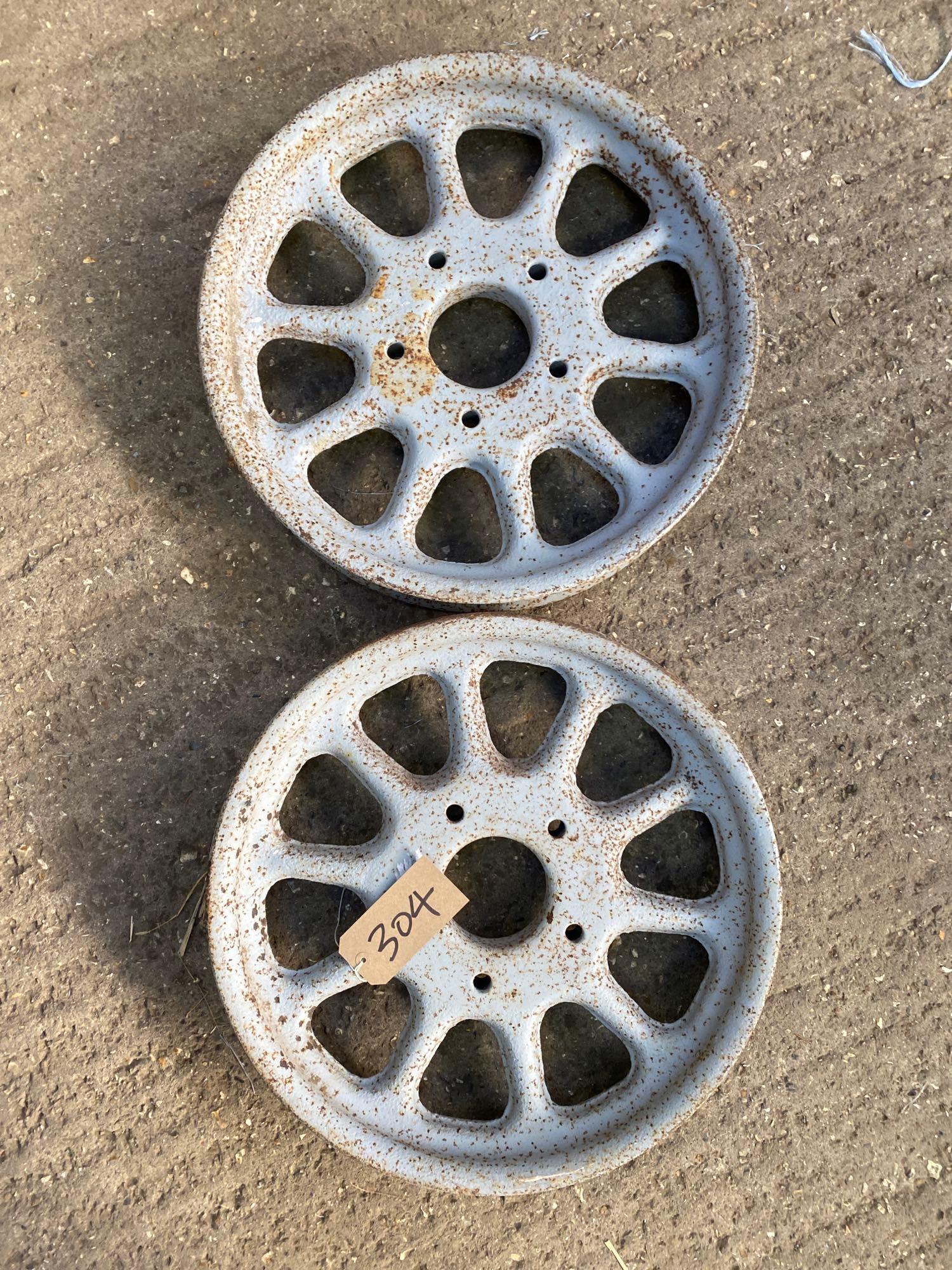 Two metal carriage wheels