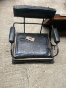 An unused carriage seat with black vinyl cushion, and another used carriage seat with padded arms an