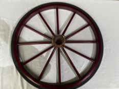 Pair of 12 spoke 4 stud wheels with solid rubber tyres, overall diameter 70cms