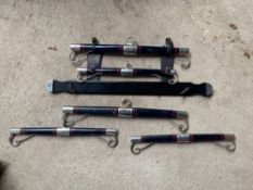 Set of Kuhnle bars together with two others on board with straps, painted navy blue with red lining.