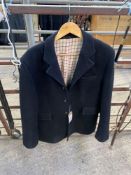 Black hunt coat with Tattersall lining. This lot carries VAT
