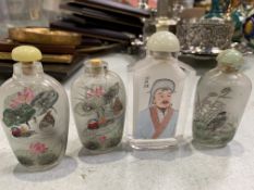 Four Chinese reverse painted glass snuff bottles