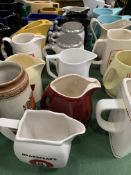 Collection of approximately 30 branded water jugs.