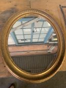 Gilt framed oval wall mirror