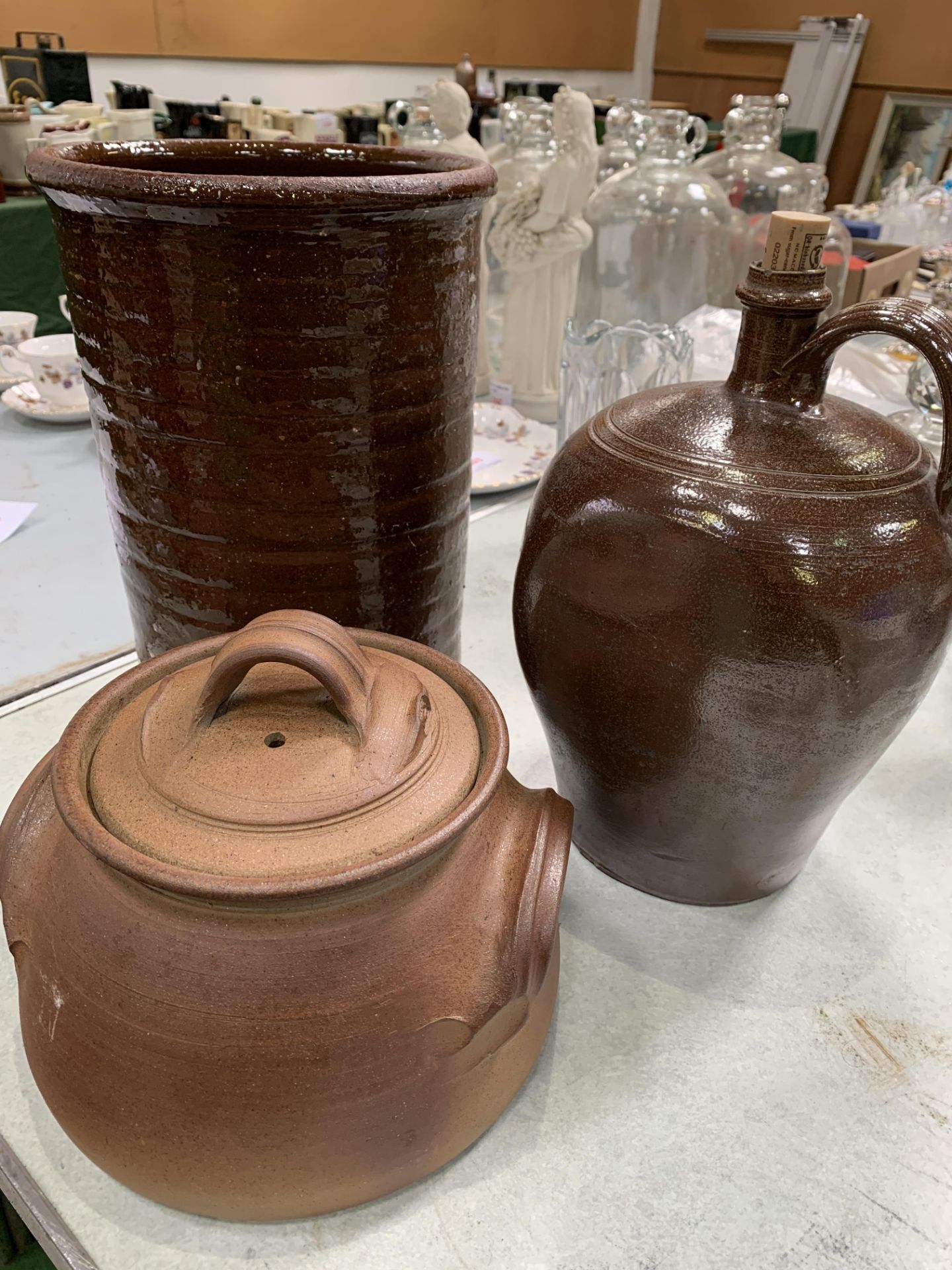 A stoneware flagon, jar and a pottery vase
