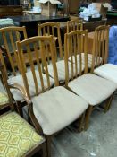Six teak frame rail back dining chairs