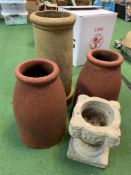 A chimney pot together with three garden pots