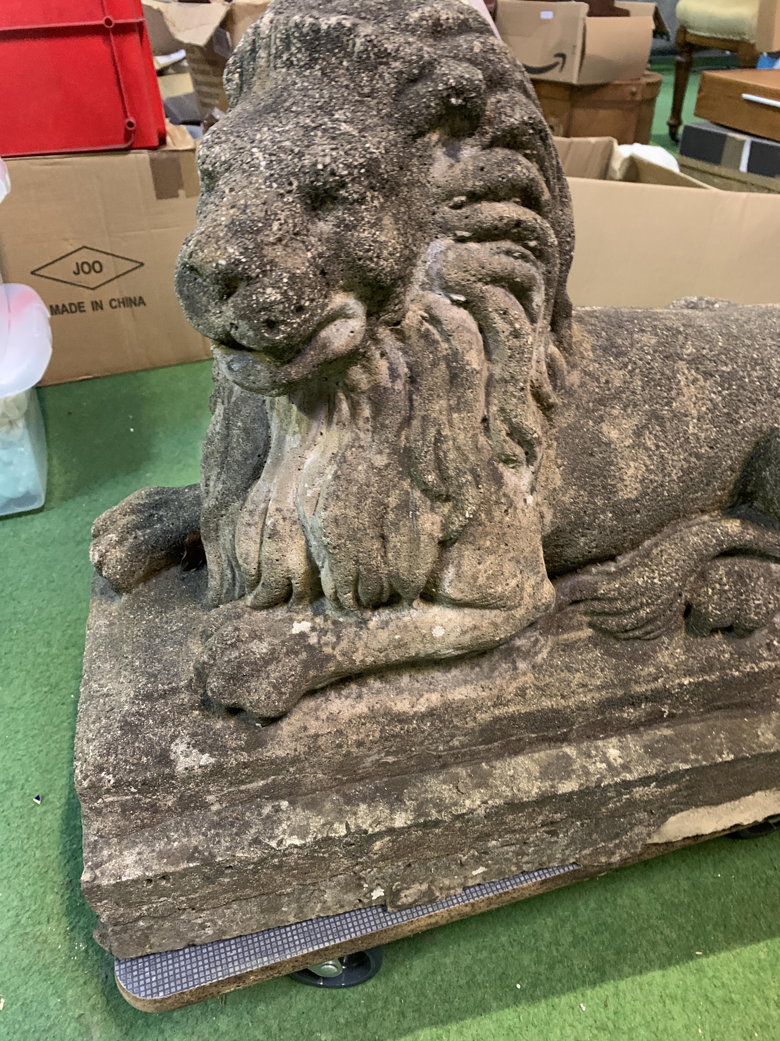 Concrete lion on plinth