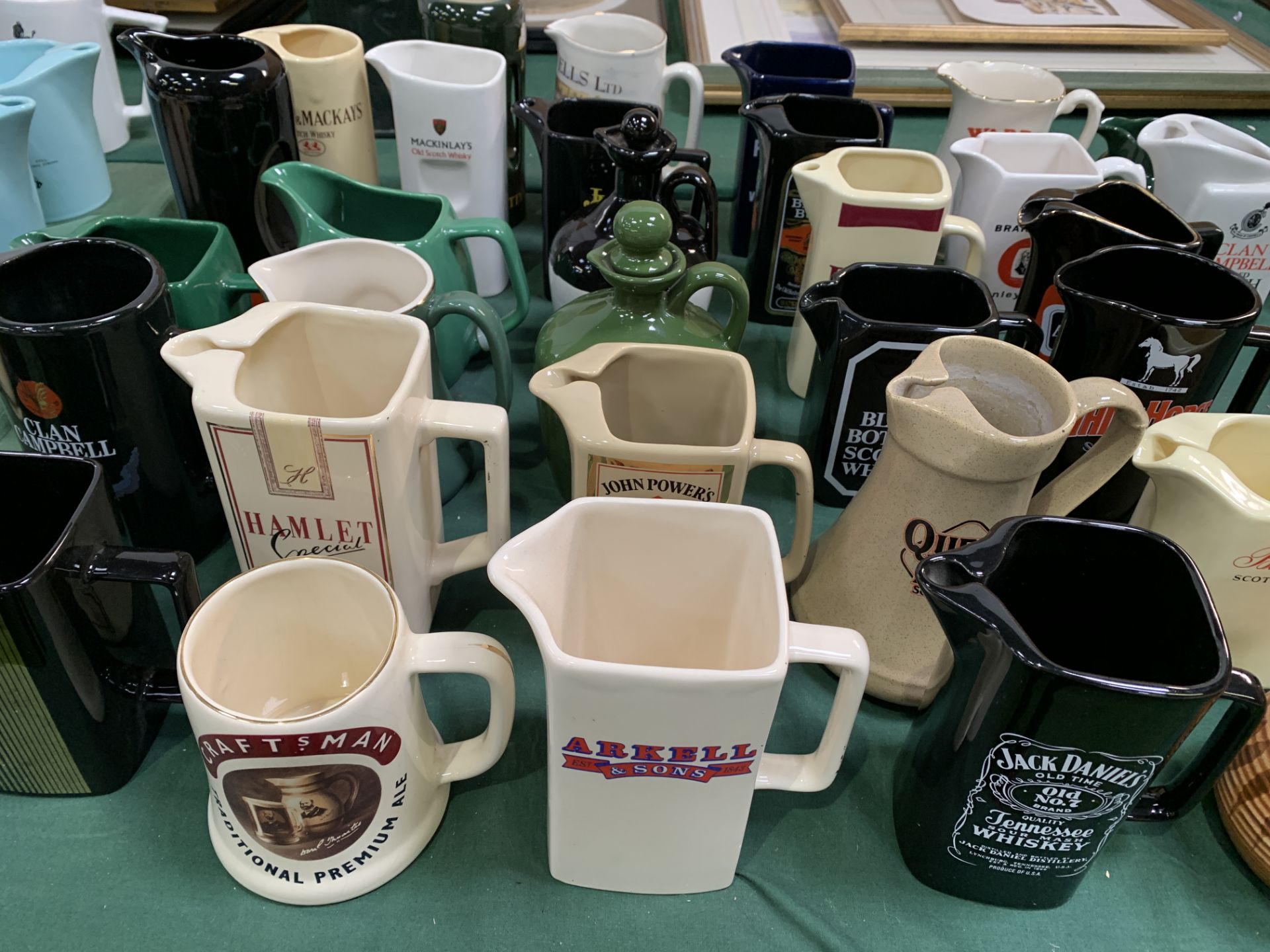 Collection of approximately 30 branded water jugs.