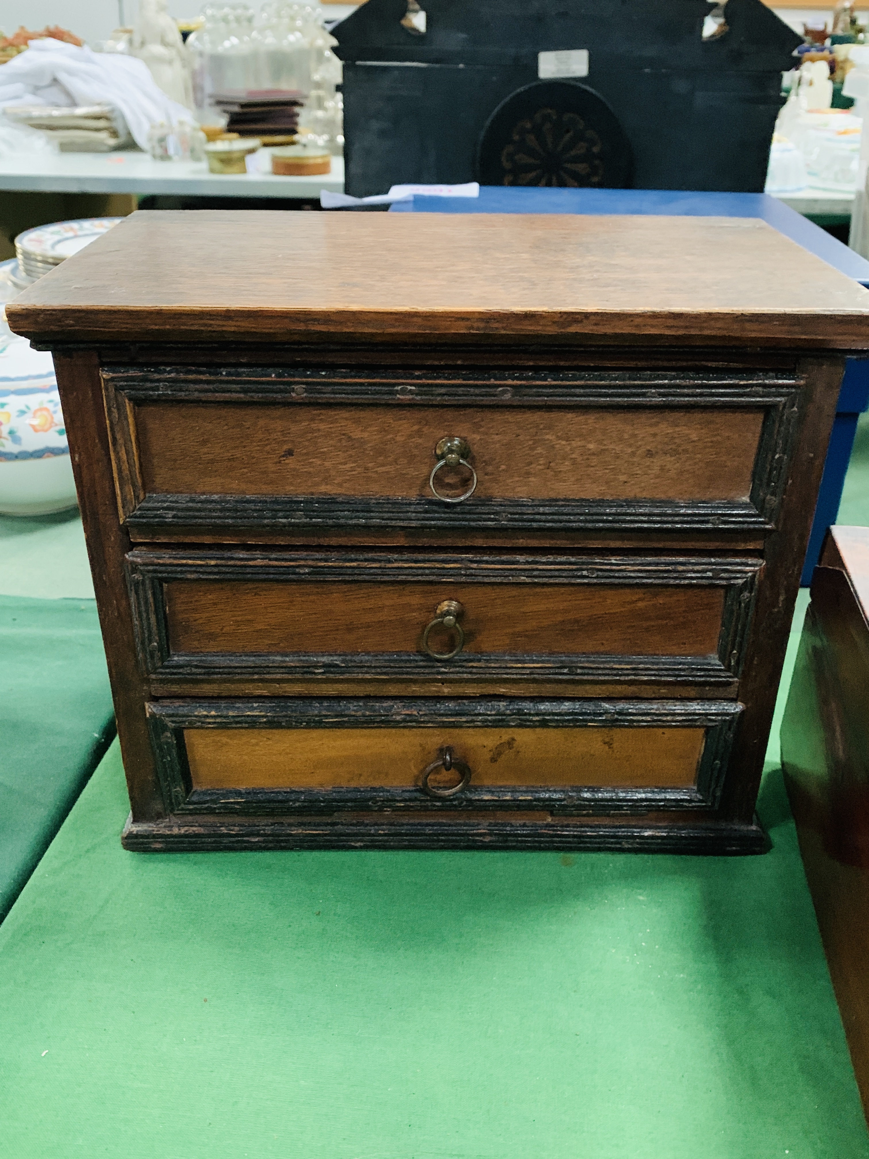 A mahogany table top chest of three drawers
