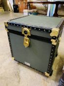 Green travel trunk on casters