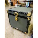 Green travel trunk on casters