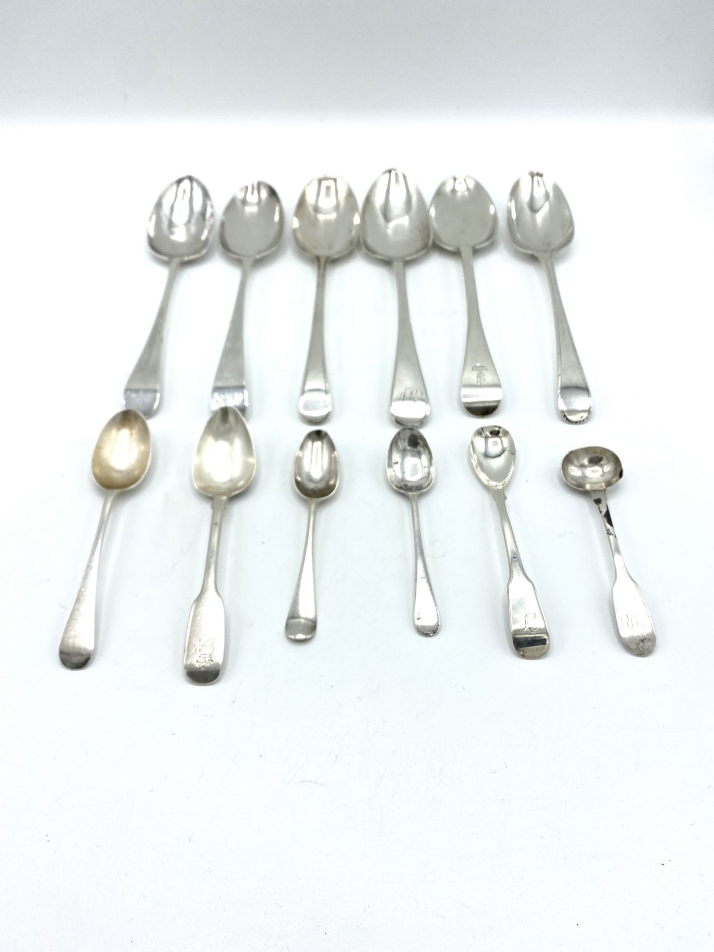 Six Georgian silver table spoons and six silver tea and cruet spoons