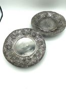 Two white metal pierced dishes