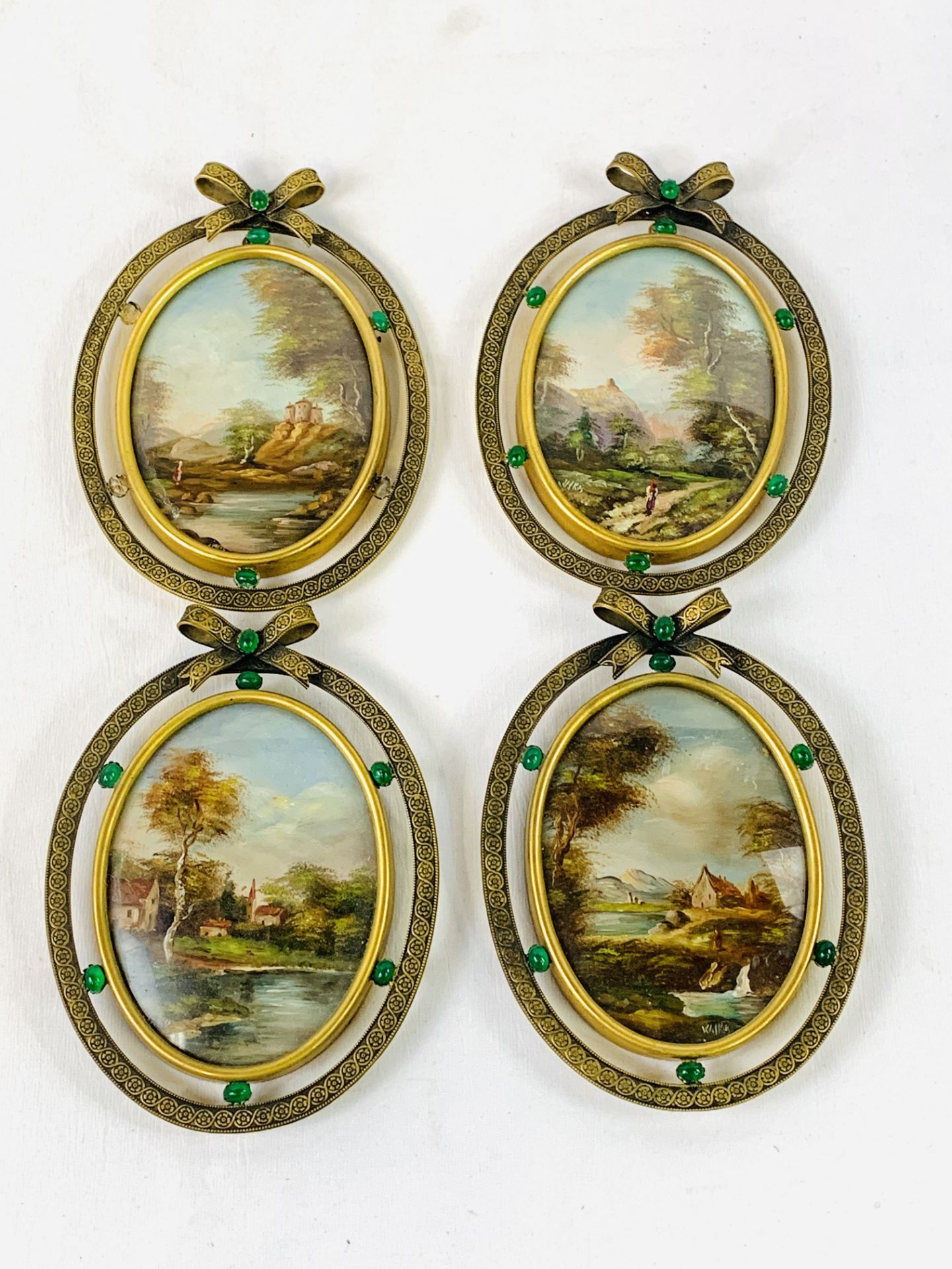 Set of four oval framed and glazed oil paintings of rural scenes in brass frames