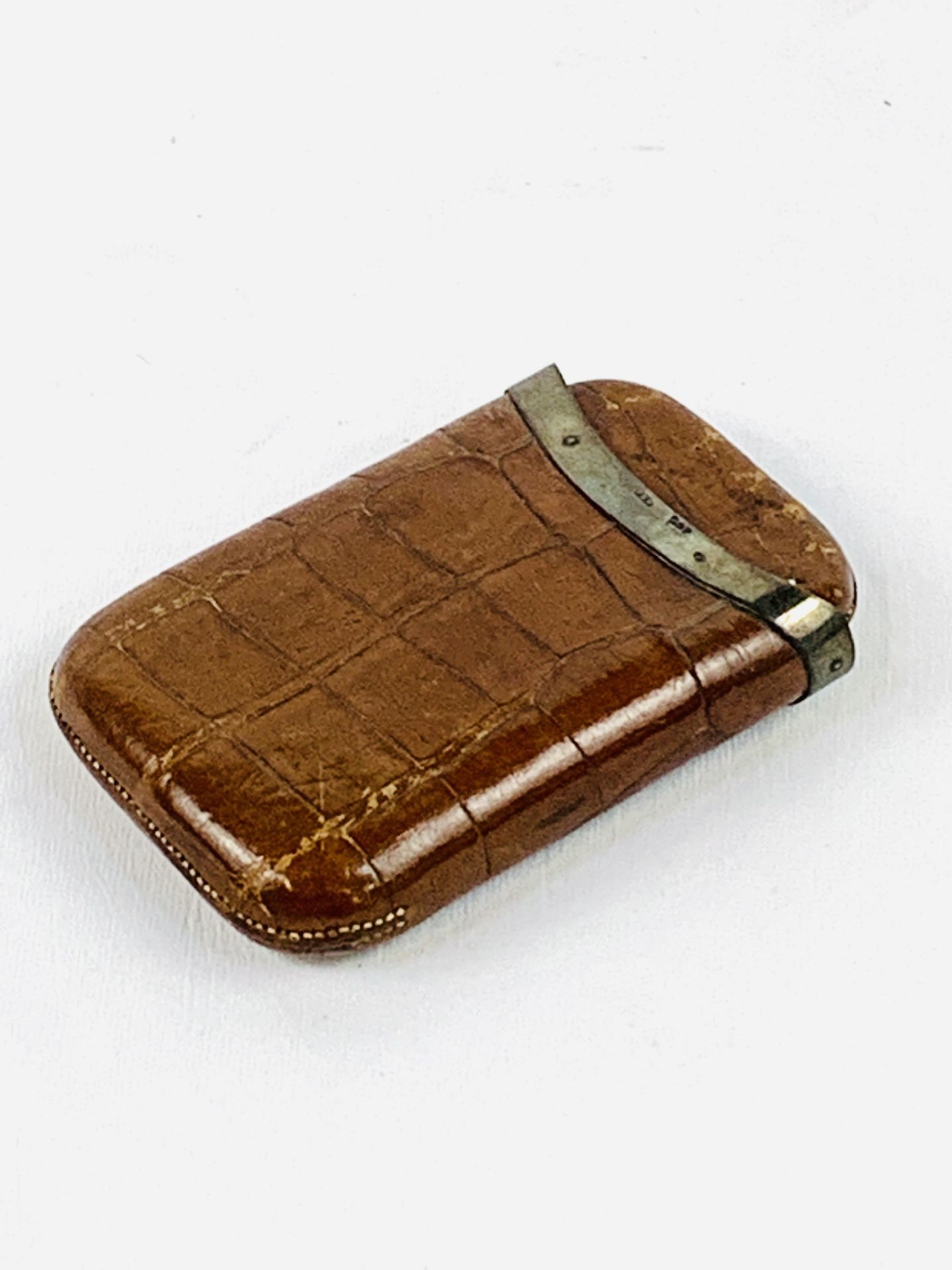 Crocodile leather cigar case with silver band.