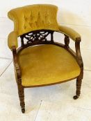 Mahogany yellow buttoned velvet upholstered open arm chair with decorative splat.