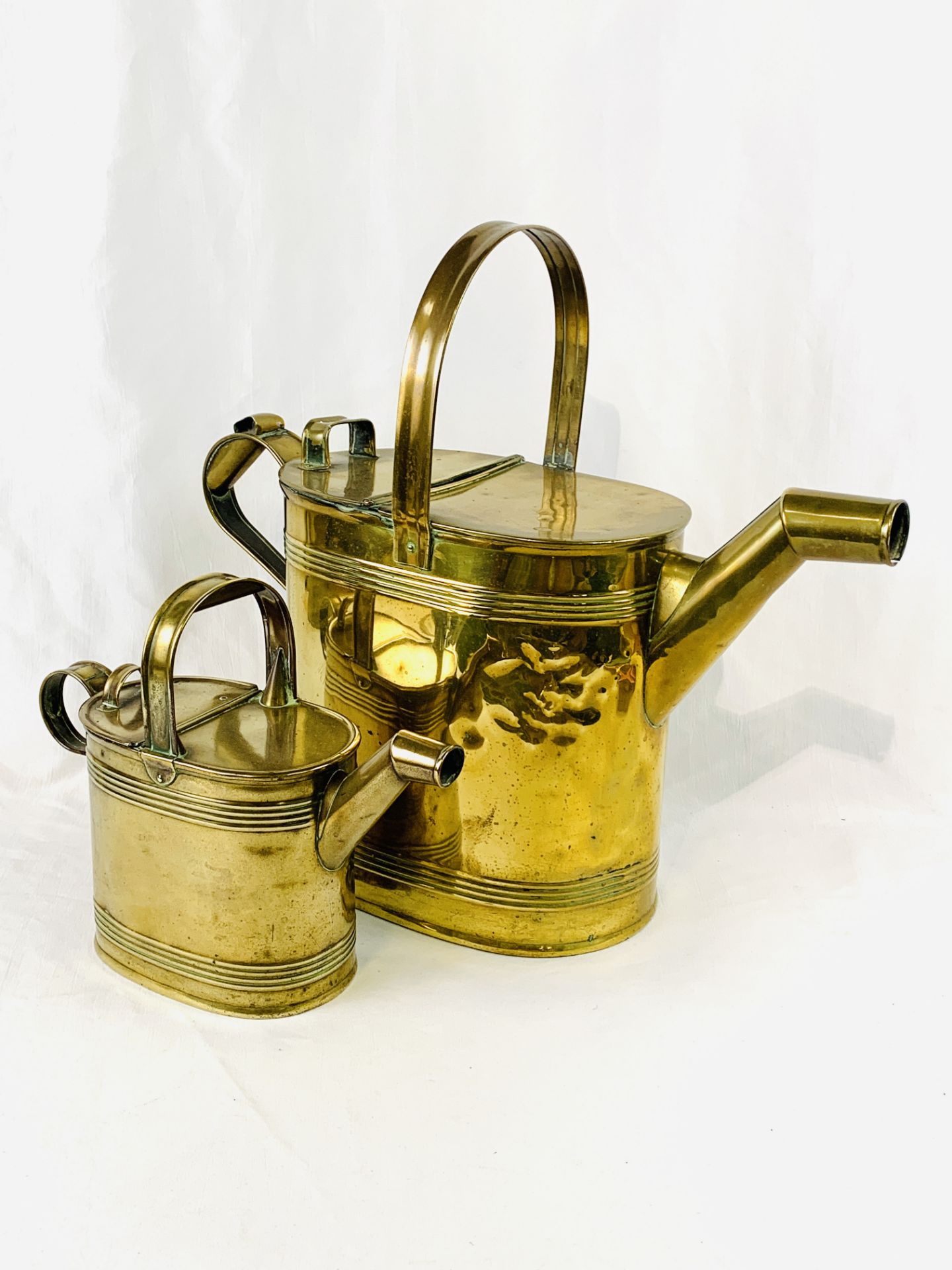 Two brass watering cans
