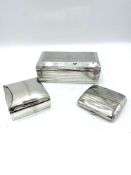 Two silver cigarette boxes and a silver cigarette case