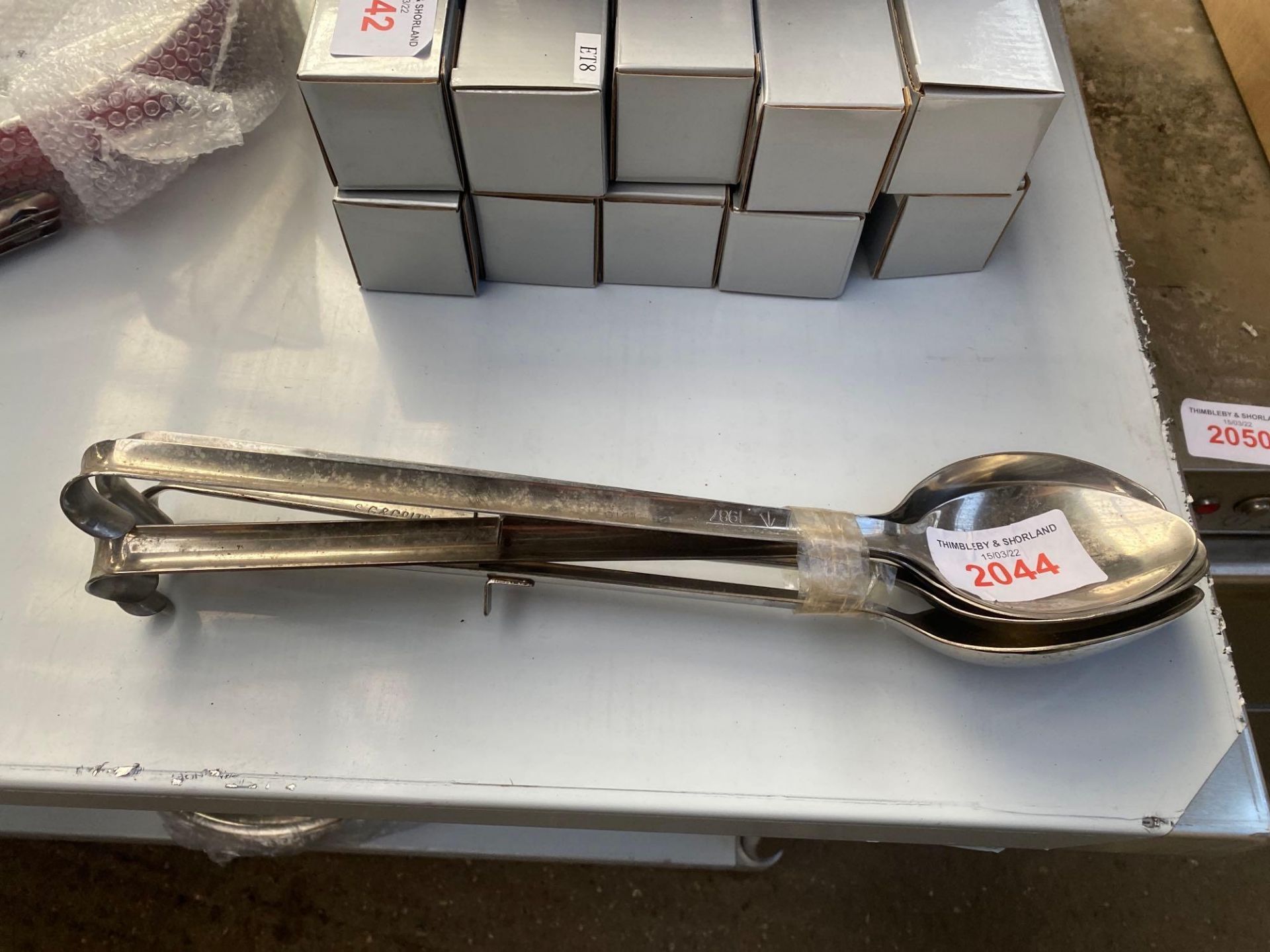 Five stainless steel serving spoons