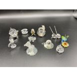 Twelve boxed items of Swarovski crystal.