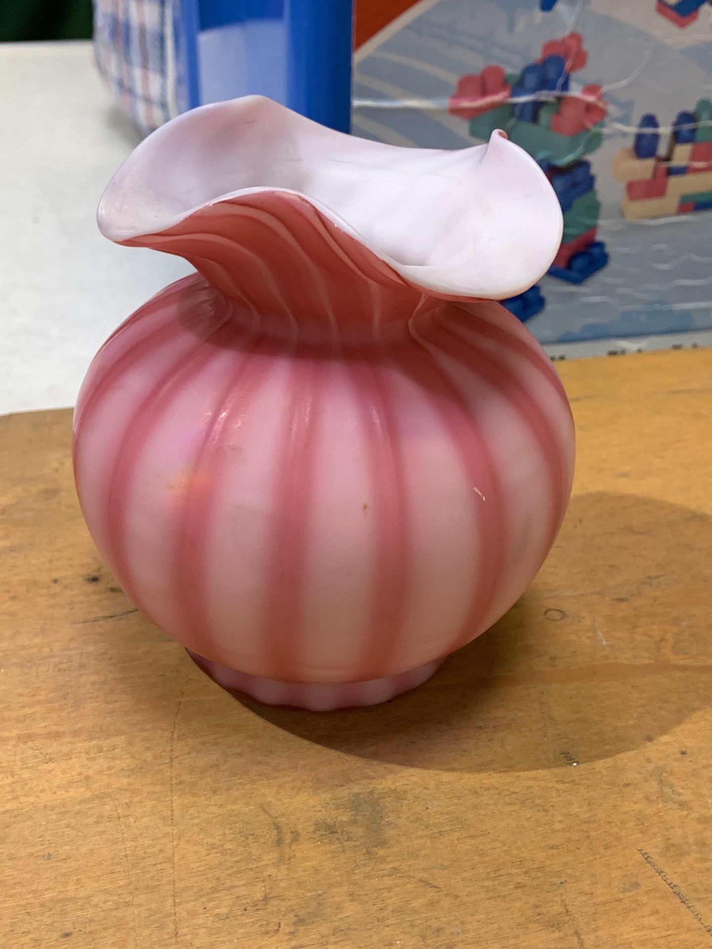 A Victorian pink striped vaseline glass vase