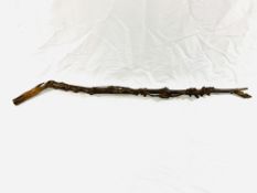 A carved wood walking stick