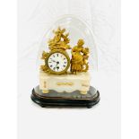 A gilt brass mantel clock on onyx base