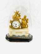 A gilt brass mantel clock on onyx base