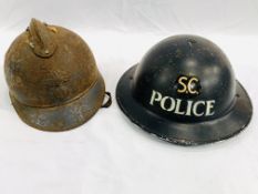 A WWII special constable helmet together with a French WWI helmet