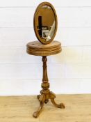 Oak veneer oval mirror mounted on a circular oak top