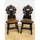 Pair of oak hall chairs with carved thistle backs