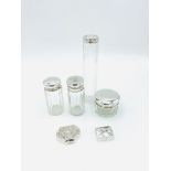 Four glass pots/bottles with hallmarked silver tops, with two silver trinket boxes