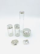 Four glass pots/bottles with hallmarked silver tops, with two silver trinket boxes
